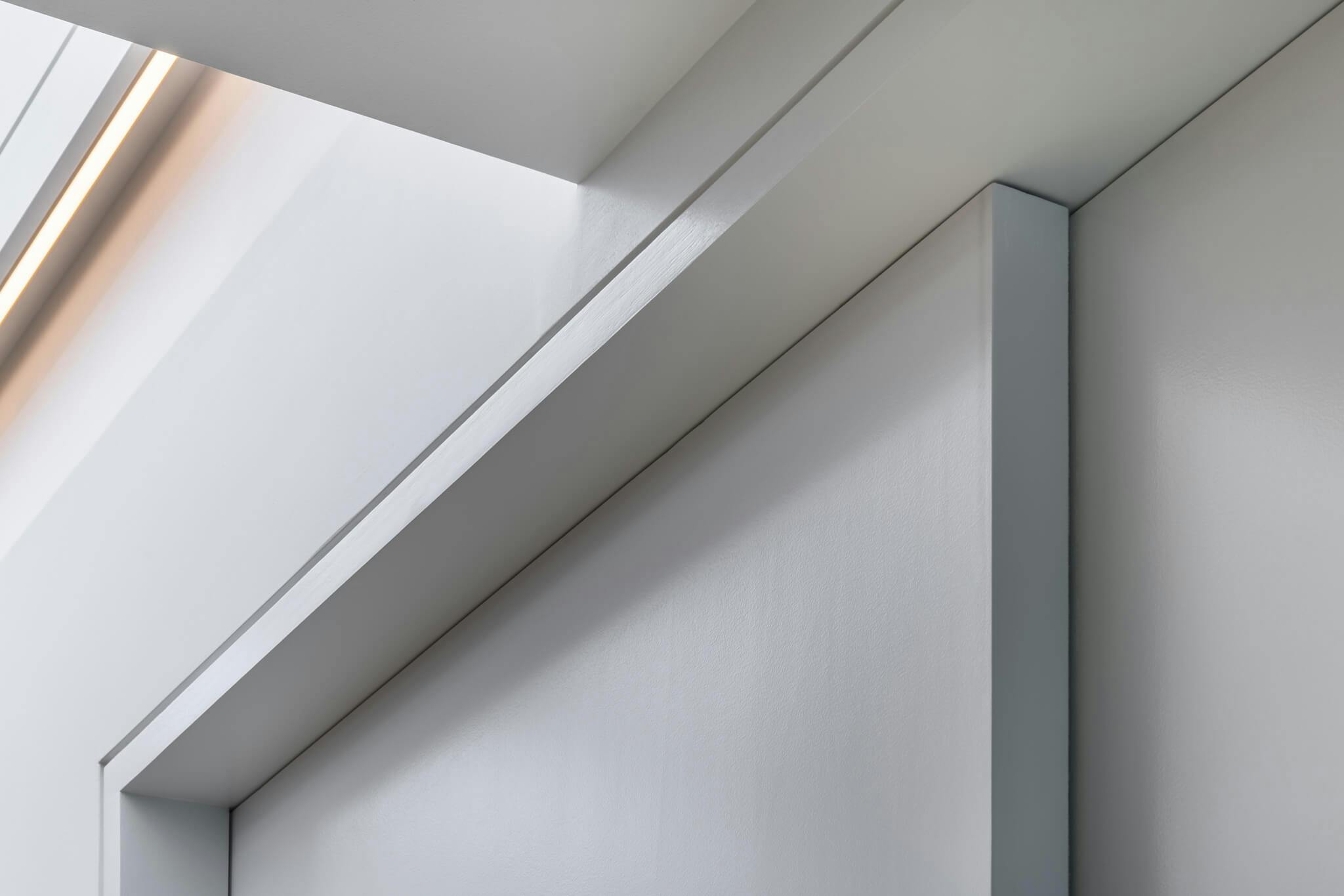 A detailed view of a set of closed white telescopic sliding doors.