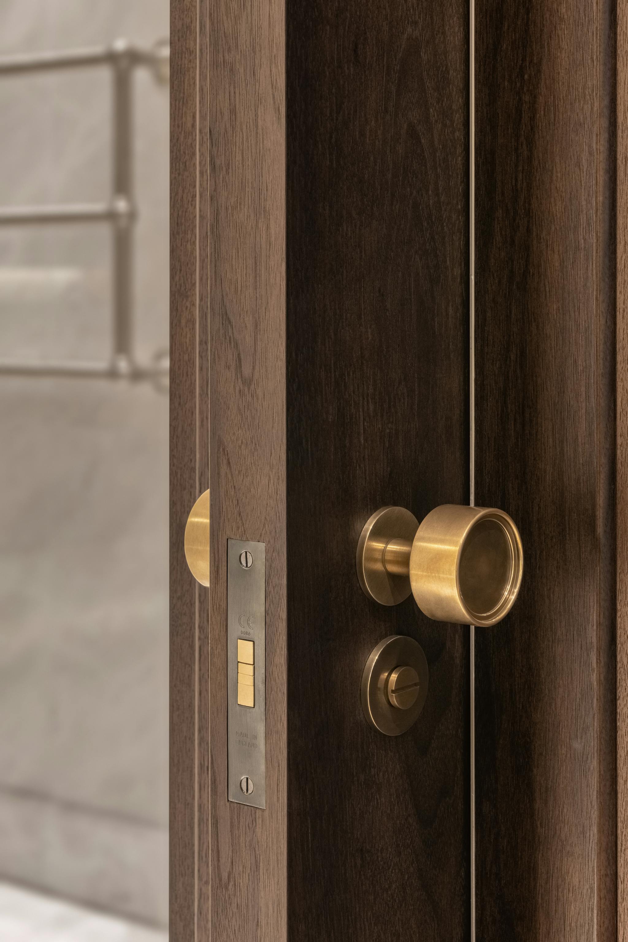 Solid brass hardware on a single sliding pocket door leading into a bathroom.